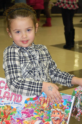 Little Girl Holding Copy of Candy Land Board Game